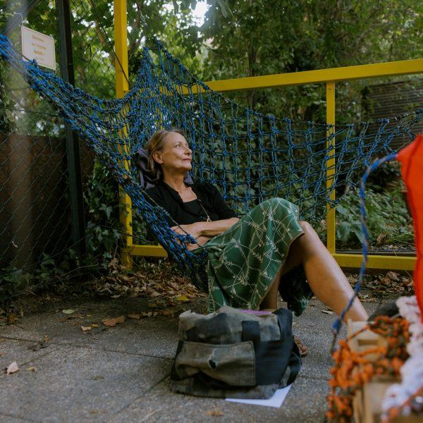 Woman sitting in Urban Networks hammock chair designed Membran for Vienna Design Week