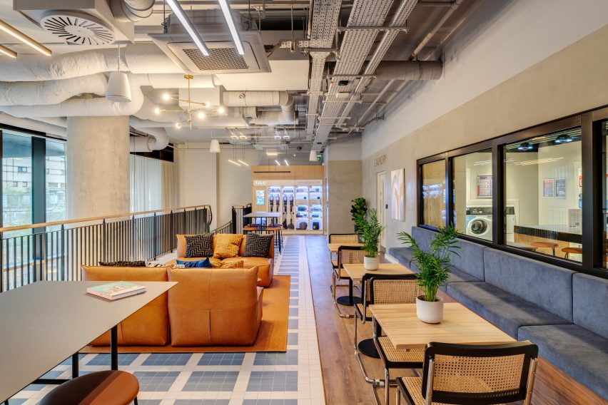Communal lounge space at College Road by HTA Design