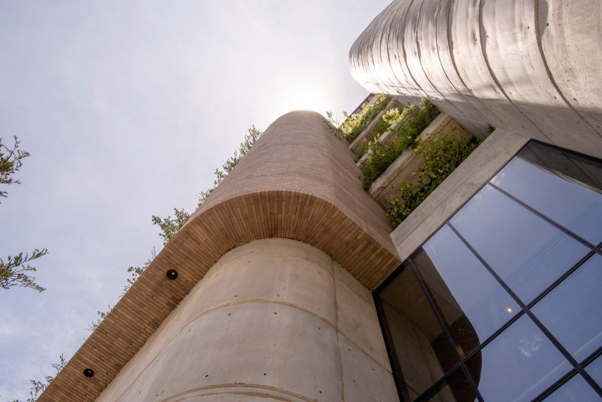 A towering office building with windows and plants