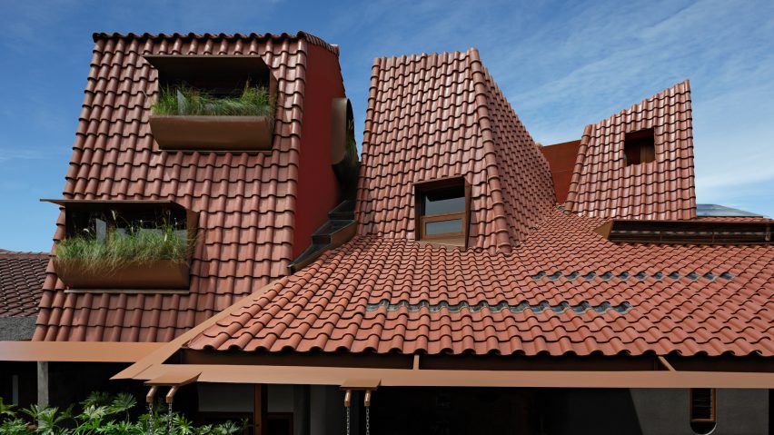Angular red-tiled roof of Distracted House by Ismail Solehudin Architecture