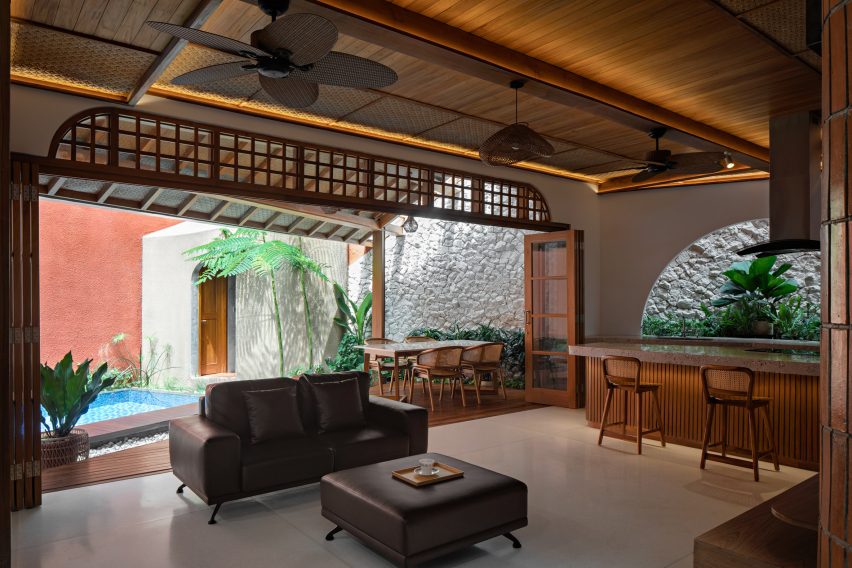 Kitchen and living space at Distracted House by Ismail Solehudin Architecture