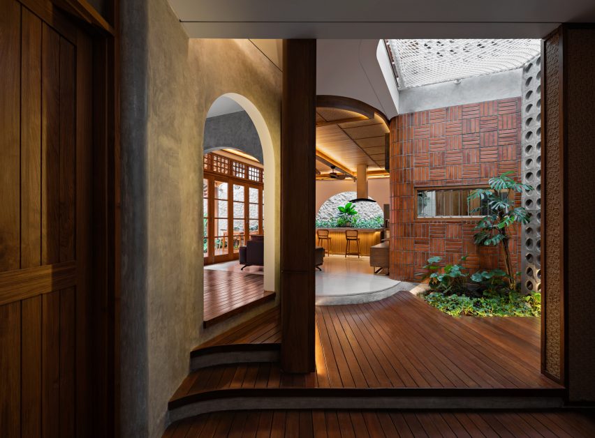 Concrete and timber interior at Distracted House by Ismail Solehudin Architecture
