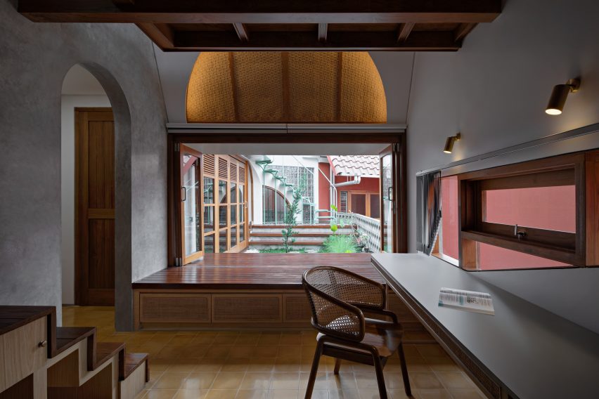 Concrete and wood interior at Distracted House by Ismail Solehudin Architecture