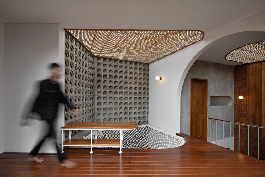 Concrete and wood-line interior of Distracted House by Ismail Solehudin Architecture