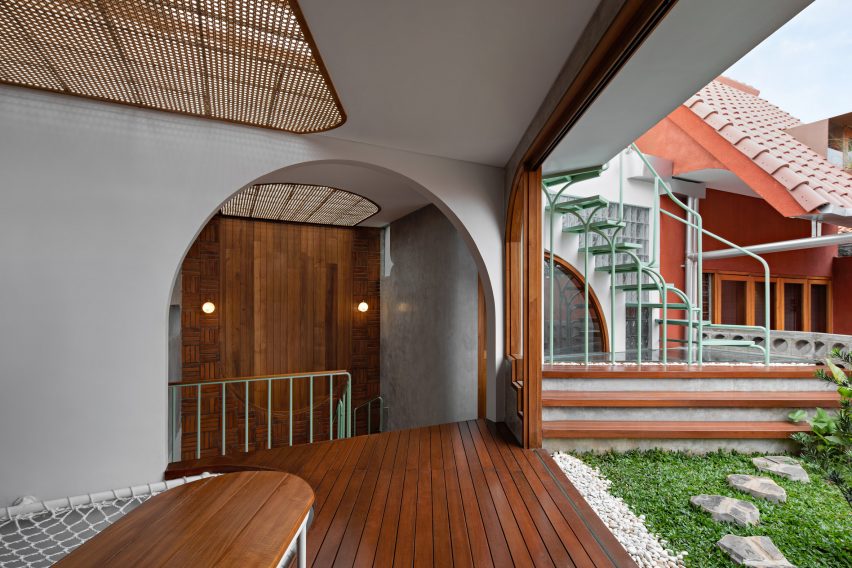 Corridor with wood flooring, archways and a grassy outdoor terrace