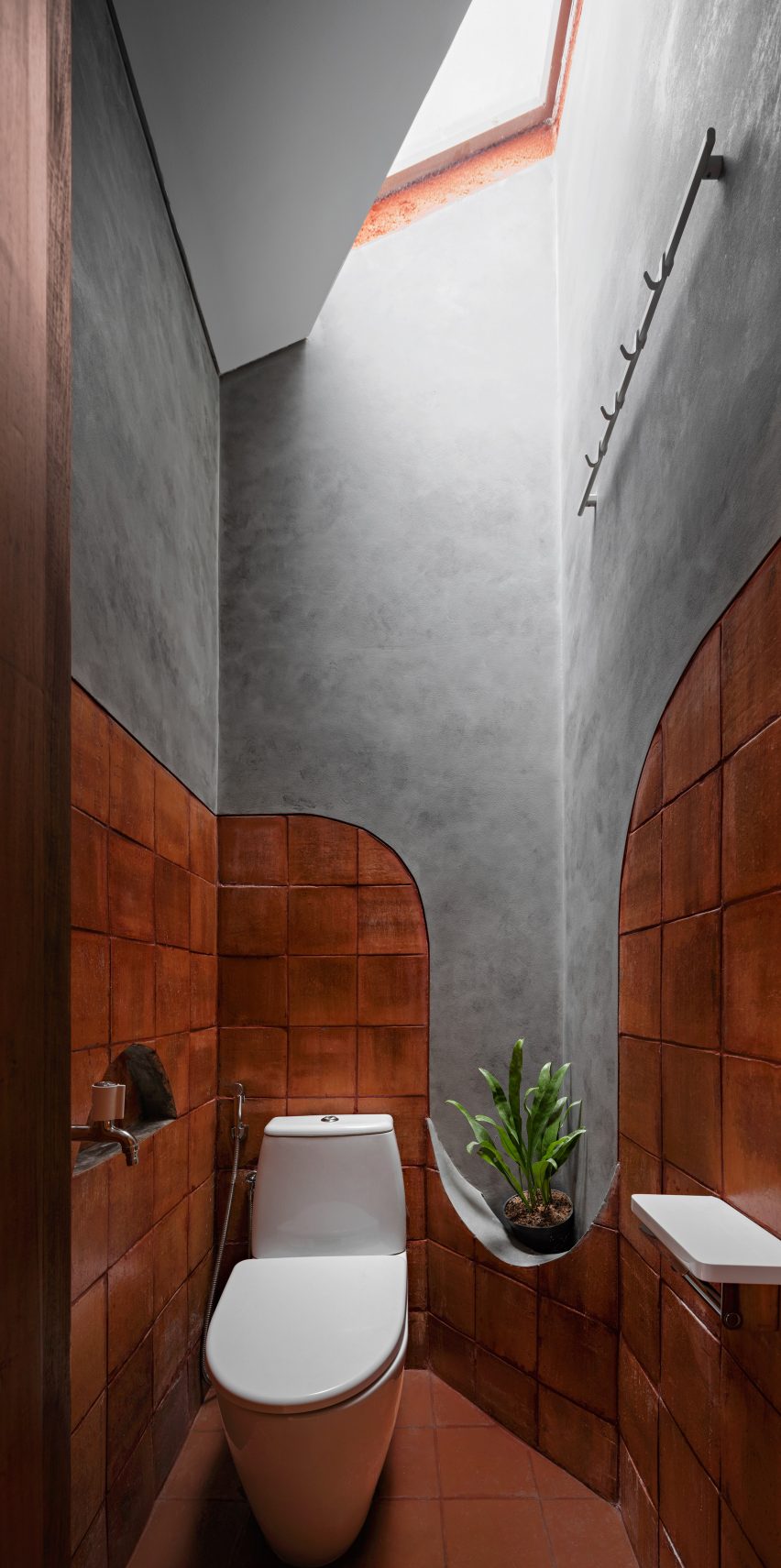 Concrete and wood bathroom with a skylight