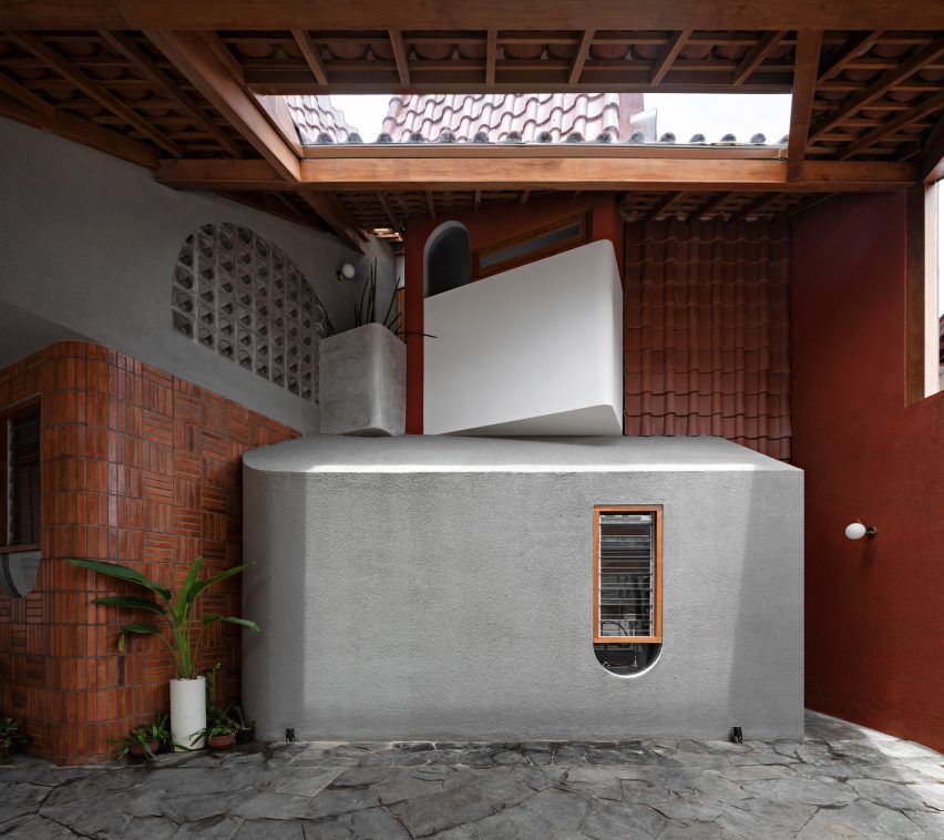 Concrete and wood interior garage at Distracted House