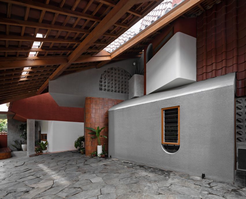 Concrete and wood interior garage at Distracted House
