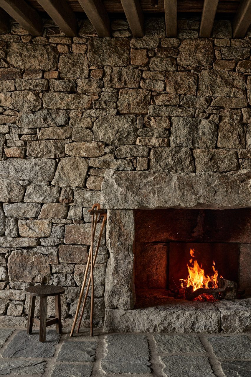 Stone wall surrounding a fireplace