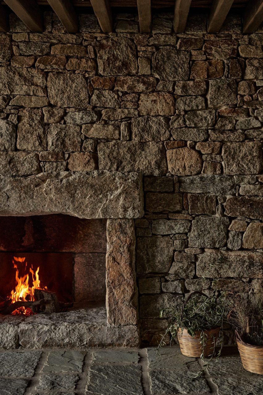 Stone wall surrounding a fireplace