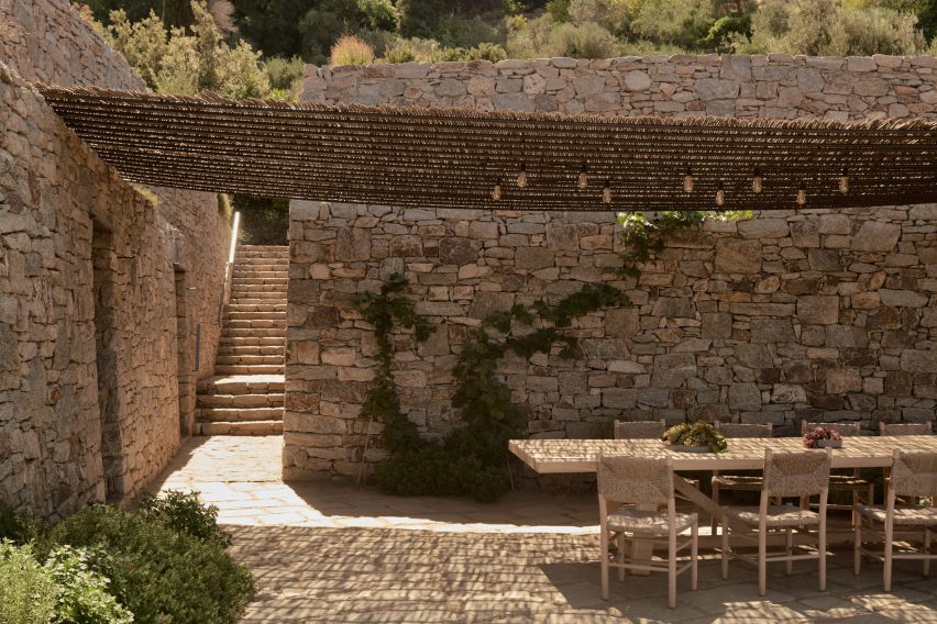 Outdoor dining table and chairs on a stone terrace