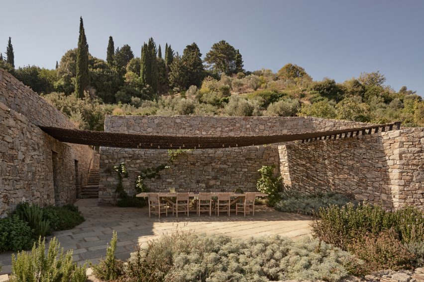 Outdoor dining table and chairs on a stone terrace
