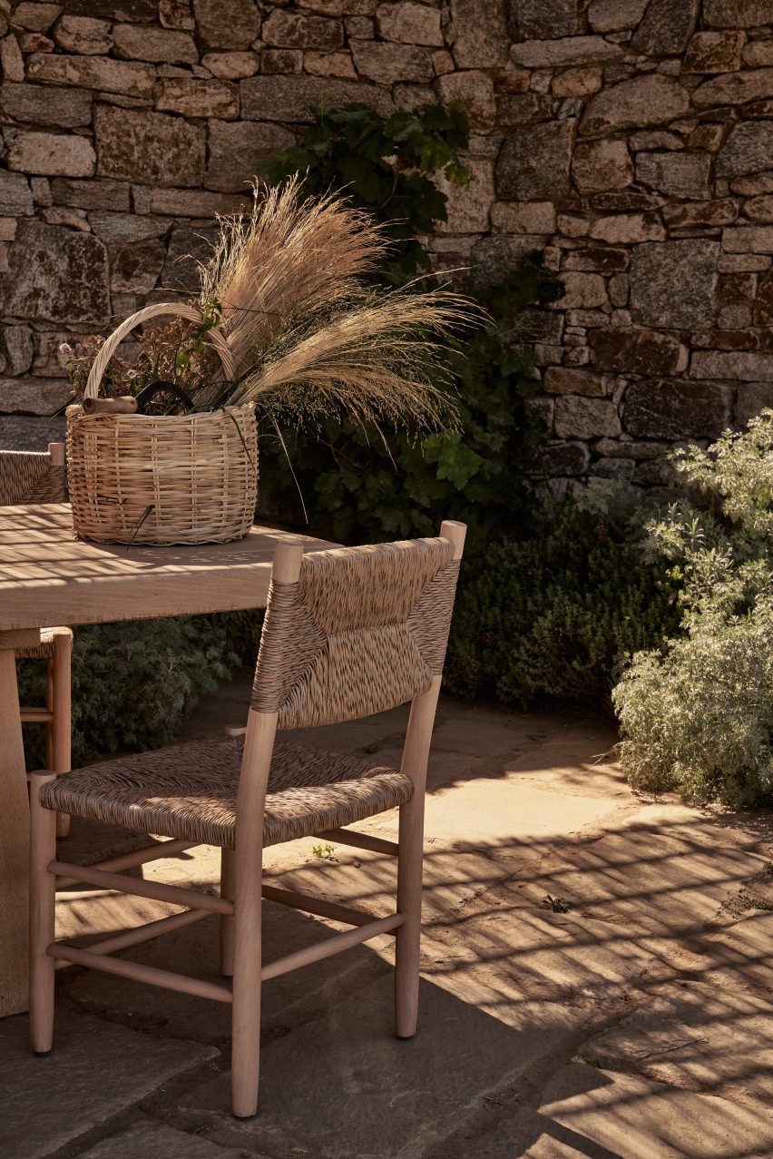 Outdoor dining table and chairs on a stone terrace