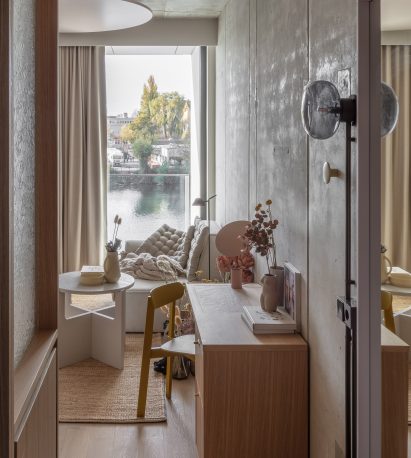 Raw concrete walls catch the grazing light from the River Spree