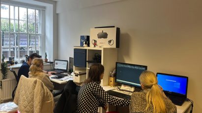 A tutor at real animation works is teaching a student to how to use AutoCAD