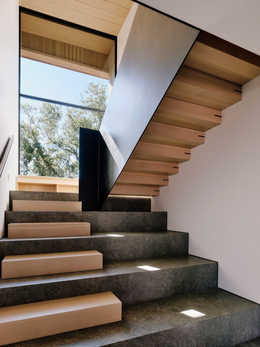 A stone staircase with wood elements