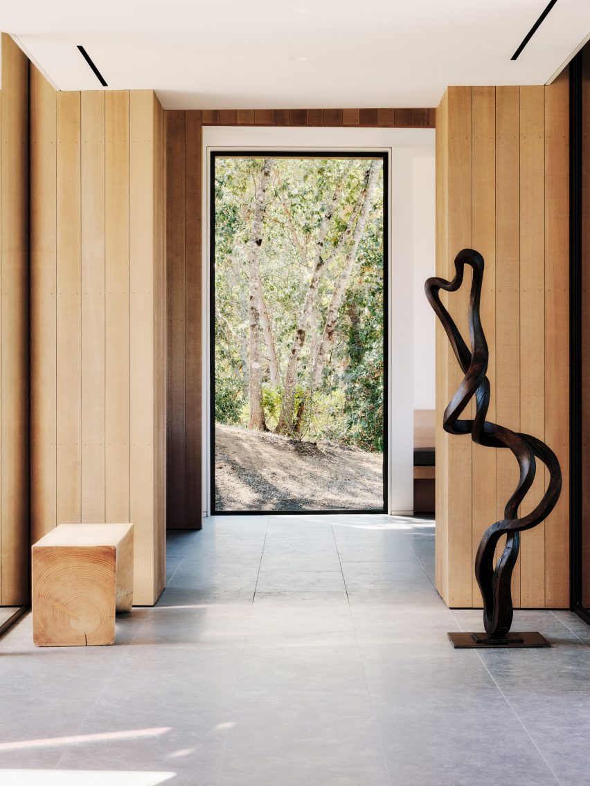 An entryway with a twisting black sculpture