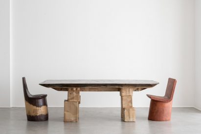Two chairs next to a long dining table