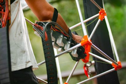 Close-up photo of an arm with a complex robotic device strapped to it
