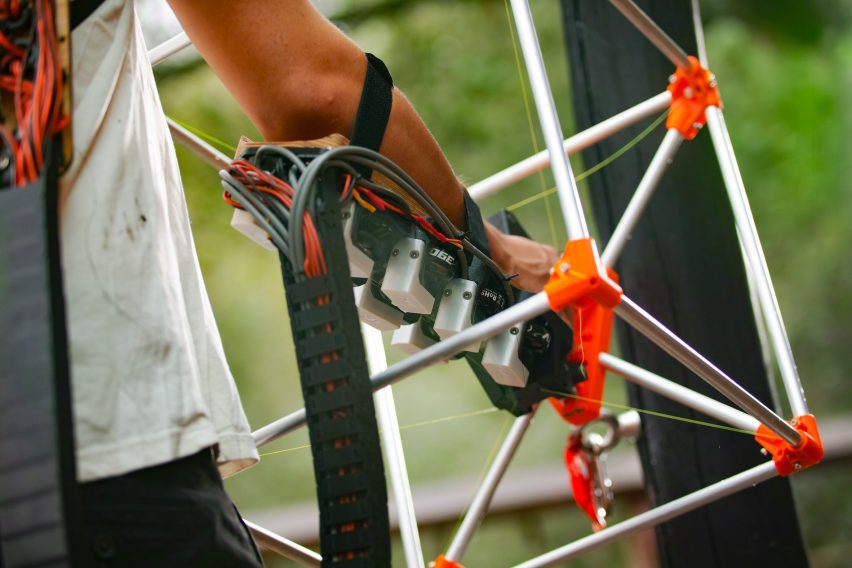 Close-up photo of an arm with a complex robotic device strapped to it
