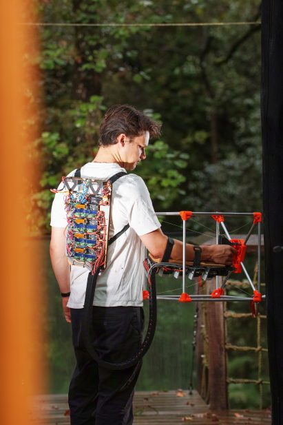 Photo of engineer Jasper Mallinson wearing his invention, the Mecha-morphis CNC device