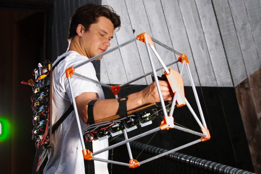 Photo of engineer Jasper Mallinson wearing the Mecha-morphis device on one arm