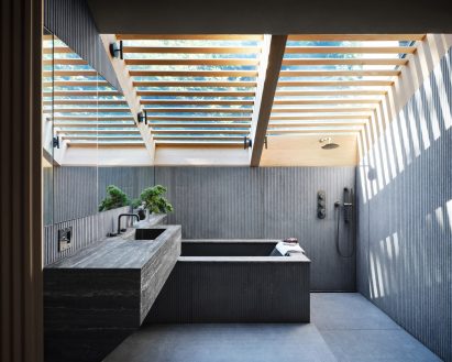 Bathroom lined with grey fibre-cement panels