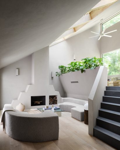 Living rooms with grey plaster walls and ziggurat-like fireplace