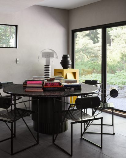 Dark dining table covered in books