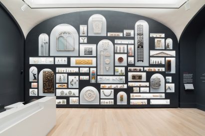 A wall with arched bookcase