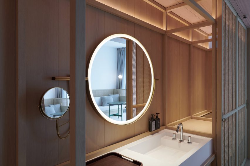 White bathroom sink on a wood wall