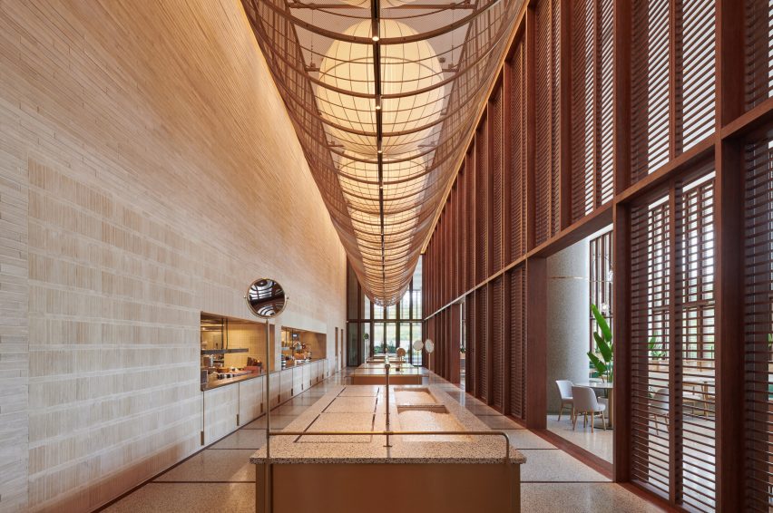 Wood-lined lobby space at the Sanya Wellness Retreat hotel in Hainan by Neri&Hu