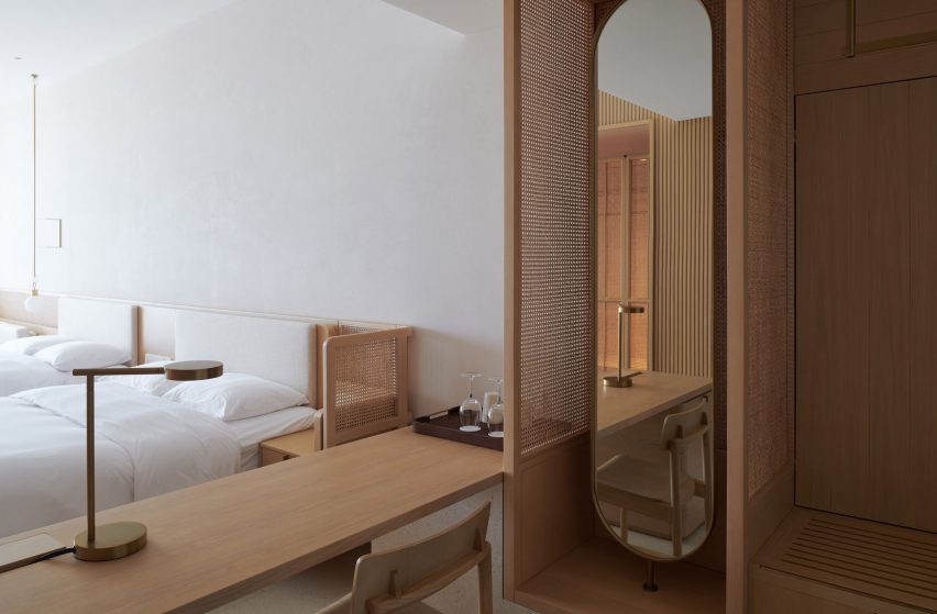 Hotel bedroom interior with rattan screens and wood furniture