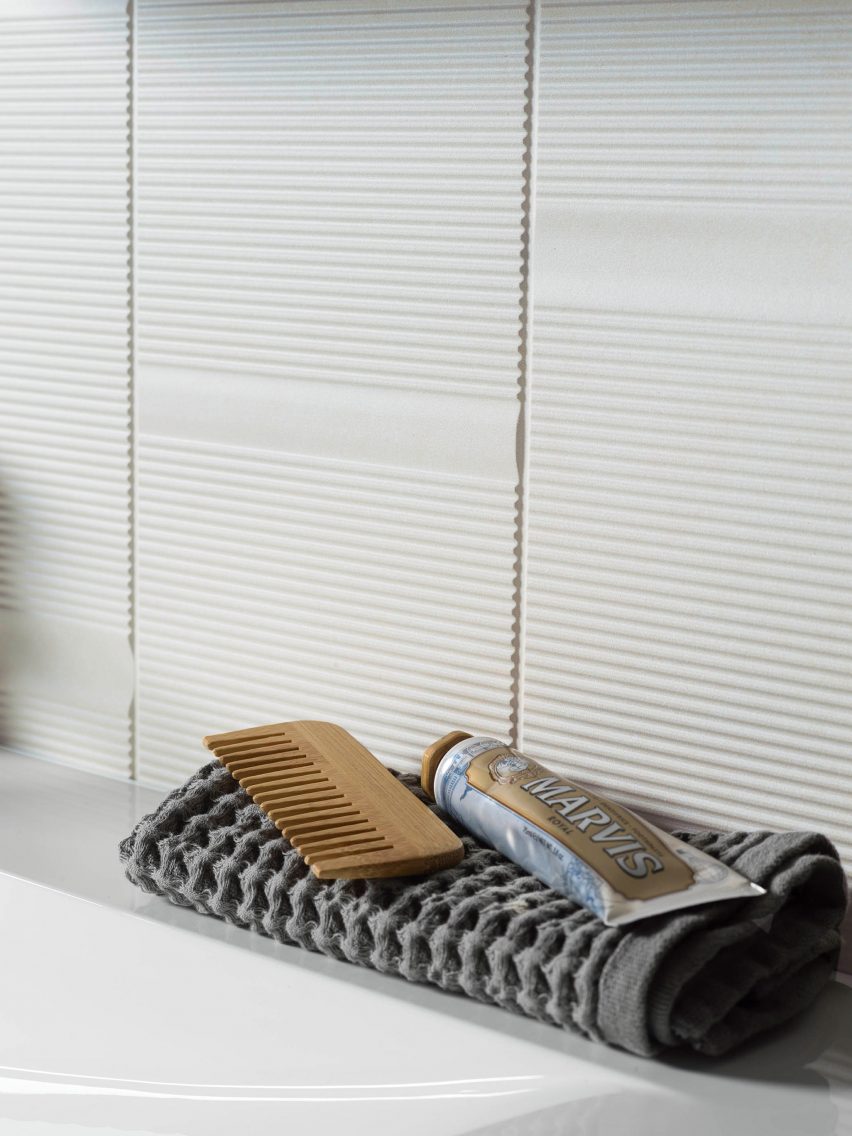 Beige tiles on bathroom wall