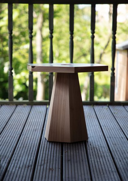Hexagonal side table on decked outside area