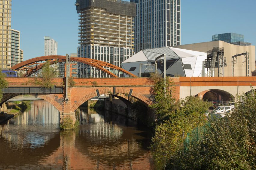 Aviva Studios in Manchester by a river