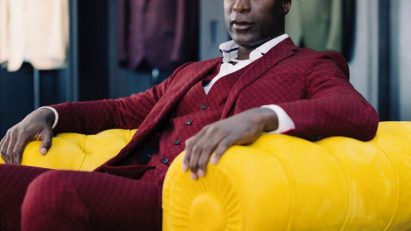 Ozwald Boateng sitting in yellow Chester armchair with embossed leather finish by Poltrona Frau