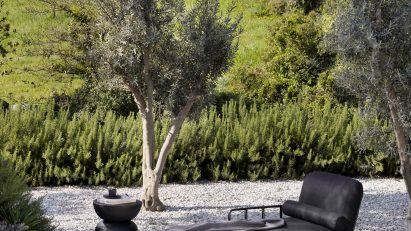 Black daybed on gravel drive