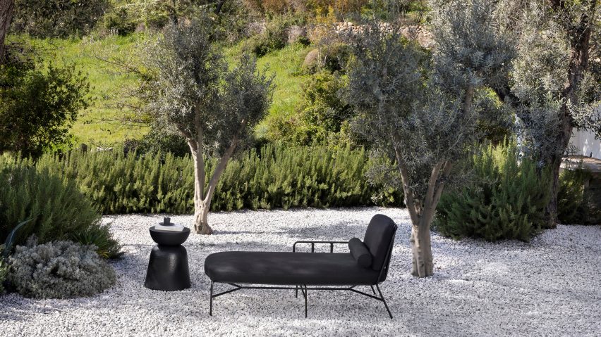 Black daybed on gravel drive