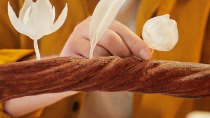 Three 3D-printed figurines on a vine