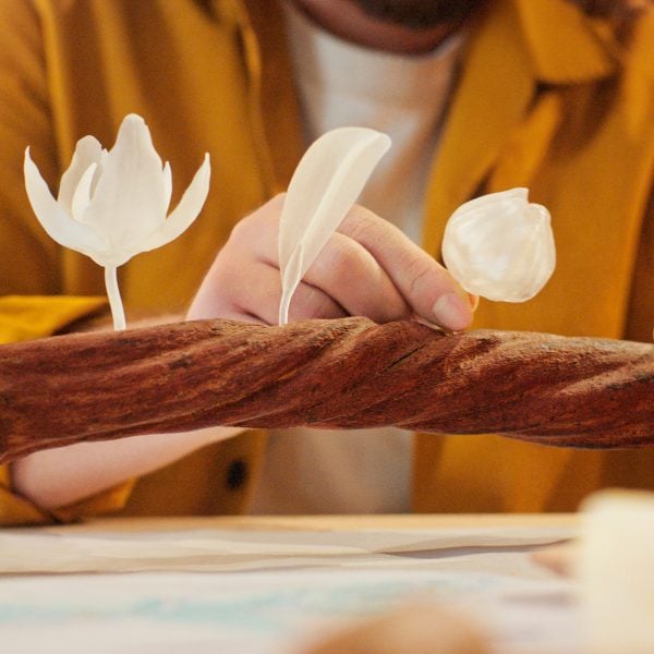 Three 3D-printed figurines on a vine