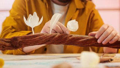 Three 3D-printed figurines on a vine