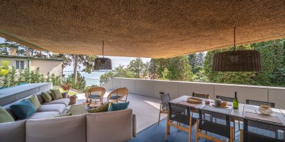 RAPA Architects' thatch roof, cantilevered holiday home in Hungary