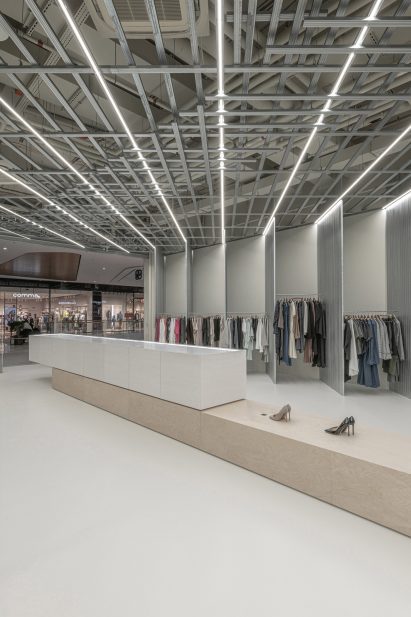 Clothes and shoes displayed inside SOM Store by D415 in Bratislava