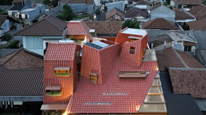 Distracted House with an angular red-tiled roof by Ismail Solehudin Architecture
