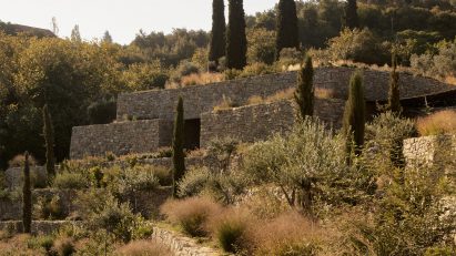 Liknon stone building on a hillside by K-studio