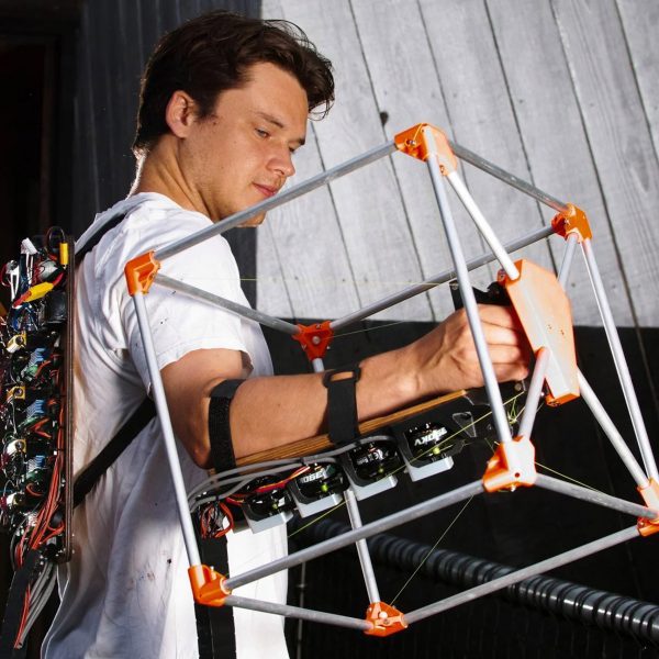 Photo of engineer Jasper Mallinson wearing the Mecha-morphis device on one arm