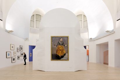 Single painting of a woman displayed on a large shrink-wrapped block