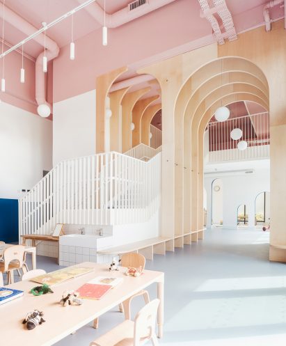 Stairway and wooden arches inside east London nursery