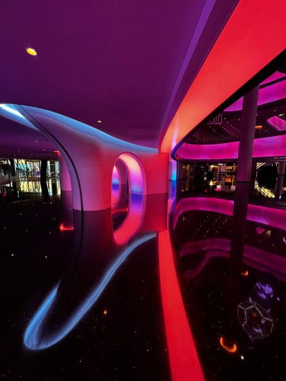 Arched opening in a pink-lit wall